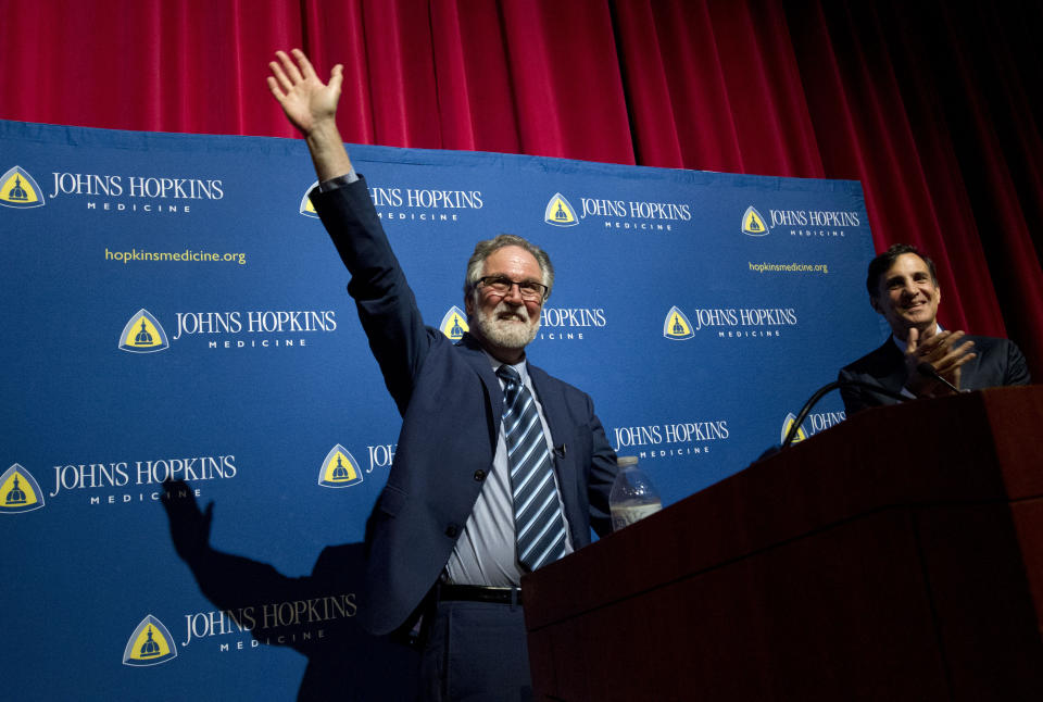 Professor Gregg Semenza, accompanied by Johns Hopkins University President Ron Daniels, waves to the crowd during a news conference after he was awarded the 2019 Nobel Prize in Medicine at Johns Hopkins Medicine Hospital in Baltimore, Md., Monday, Oct. 7, 2019. The 2019 Nobel Prize in Medicine has been jointly awarded to William Kaelin Jr., Sir Peter Ratcliffe and Gregg Semenza for their pioneering research into how human cells respond to changing oxygen levels. (AP Photo/Jose Luis Magana)