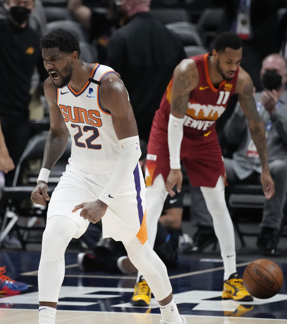 Phoenix Suns center Deandre Ayton reacts after dunking the ball in the second half of Game 4 of an NBA second-round playoff series against the Denver Nuggets, Sunday, June 13, 2021, in Denver. Phoenix won 125-118 to sweep the series. (AP Photo/David Zalubowski)