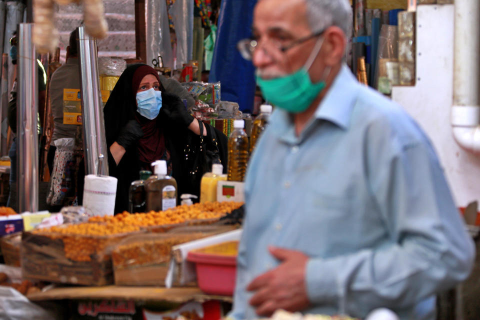 People shop in preparation for the Muslim fasting month of Ramadan, in Baghdad, Iraq, Tuesday, April 21, 2020. Ramadan begins with the new moon later this week, Muslims all around the world are trying to work out how to maintain the many cherished rituals of Islam's holiest month. (AP Photo/Hadi Mizban)