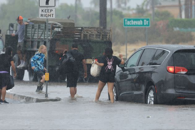 Motorists leave their vehicle stuck on a flooded road during heavy rains from Hilary in Palm Springs, California, on Aug. 20.