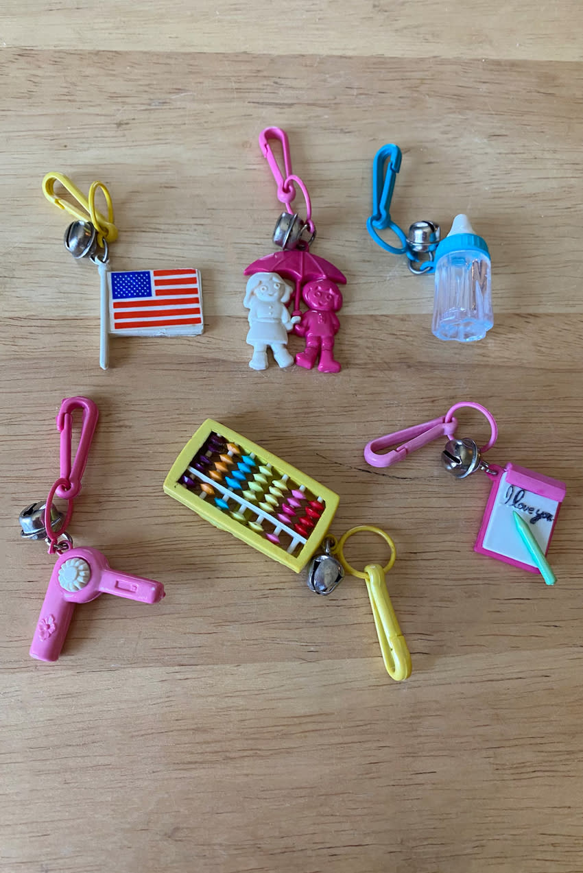 6 colorful 1980s Bell Charms on a wooden background