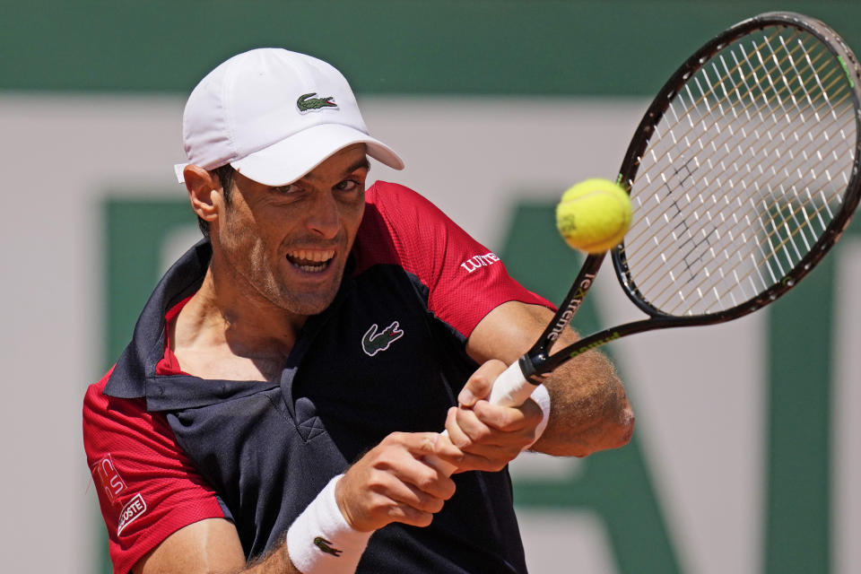 Spain's Pablo Andujar backhands to Austria's Dominic Thiem during their first round match of the French Open tennis tournament at the Roland Garros stadium Sunday, May 30, 2021 in Paris. (AP Photo/Christophe Ena)
