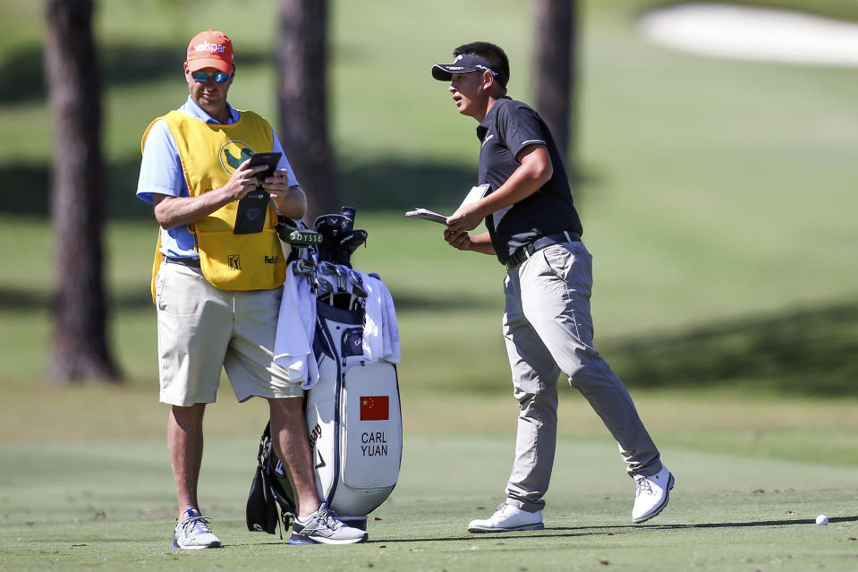 Carl Yuan of China looks for the distance marker on the first fairway during the third day of the Sanderson Farms Championship golf tournament in Jackson, Miss., Saturday, Oct 7, 2023. (James Pugh/impact601.com via AP)