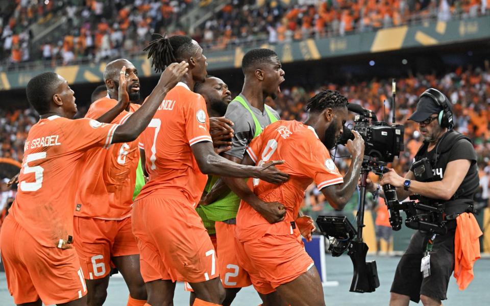 Ivory Coast players celebrate after Ivory Coast's midfielder #8 Franck Kessie scored their team's first goal during the Africa Cup of Nations (CAN) 2024 final football match between Ivory Coast and Nigeria at Alassane Ouattara Olympic Stadium in Ebimpe, Abidjan on February 11, 202
