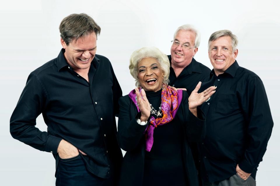 Director and Producer Todd Thompson (left), the late actress Nichelle Nichols (center), Producer David Teek (back), and Producer Tim Franta (right) take photos for the documentary film "Woman in Motion."