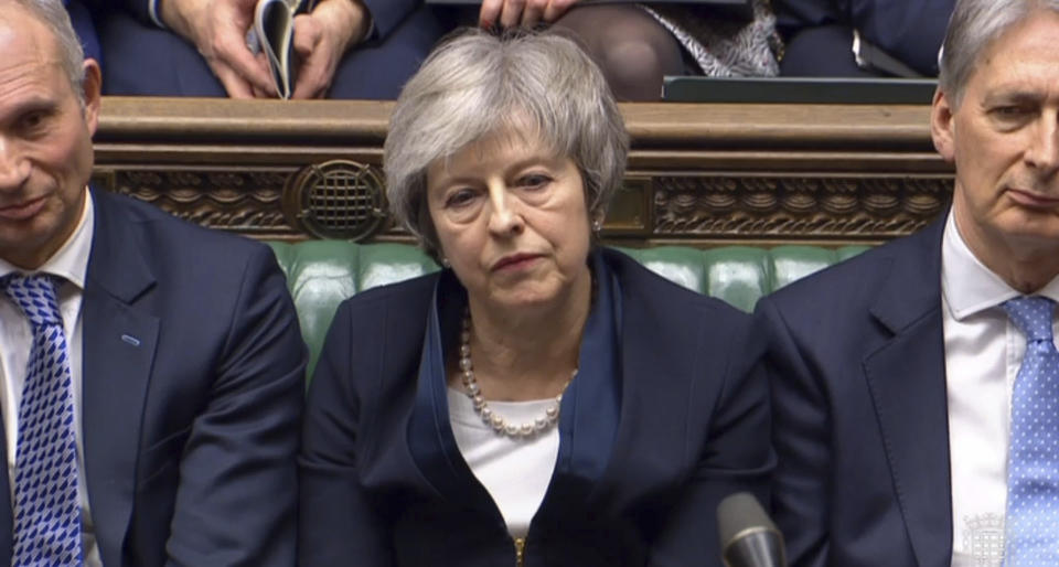 In this grab taken from video, Britain's Prime Minister Theresa May listens to Labour leader Jeremy Corbyn speaking after losing a vote on her Brexit deal, in the House of Commons, London, Tuesday Jan. 15, 2019. British lawmakers have plunged Brexit into chaos and the U.K. politics into crisis by rejecting Prime Minister Theresa May's divorce deal with the European Union. The 432 to 202 vote in the House of Commons was widely expected but still devastating for May, whose fragile leadership is now under siege. (House of Commons/PA via AP)