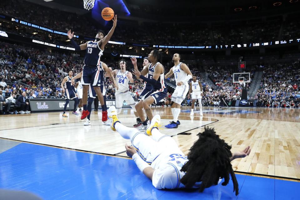 Gonzaga guard Malachi Smith grabs a rebound on a missed shot by UCLA guard Tyger Campbell.