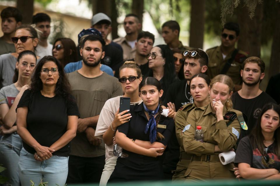 Family and friends of a fallen Israeli soldier attend his funeral on Oct. 9, 2023, in Kfar Menachem.