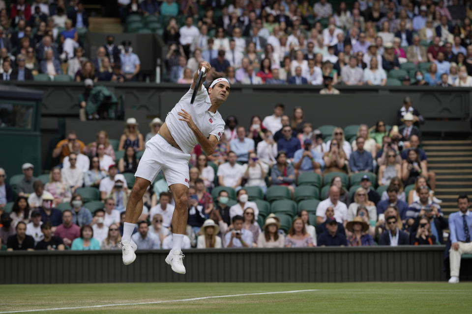 Switzerland's Roger Federer serves to Britain's Cameron Norrie during the men's singles third round match on day six of the Wimbledon Tennis Championships in London, Saturday July 3, 2021. (AP Photo/Alastair Grant)