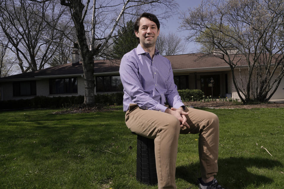 Patrick Proctor Brown poses for a picture outside his Elm Grove, Wis., home on April 23, 2021. At the 100-day mile marker, polls show most Americans are giving Biden positive marks for his early performance, particularly for his management of coronavirus pandemic. But in one pocket of swing-state Wisconsin, where a suburban surge helped put Biden in the White House, interviews with voters show that support often falls short of adulation (AP Photo/Morry Gash)