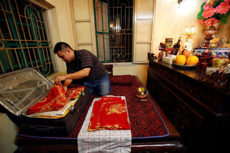 Vietnamese medium Nguyen Duy Nam, prepares his costumes at his house in Hanoi, Vietnam, May 4, 2017. REUTERS/Kham