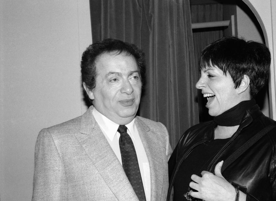 FILE - In this Feb. 4, 1991, file photo, Liza Minnelli chats with comic Jackie Mason during a visit backstage at the Neil Simon Theater in New York. Minnelli had dropped by to congratulate Mason on his new Broadway show, "Brand New." Mason, a rabbi-turned-jokester whose feisty brand of standup comedy got laughs from nightclubs in the Catskills to West Coast talk shows and Broadway stages, has died. He was 93. Mason died Saturday, July 24, 2021, in Manhattan, the celebrity lawyer Raoul Felder told The Associated Press. (AP Photo/Michael Simon, File)