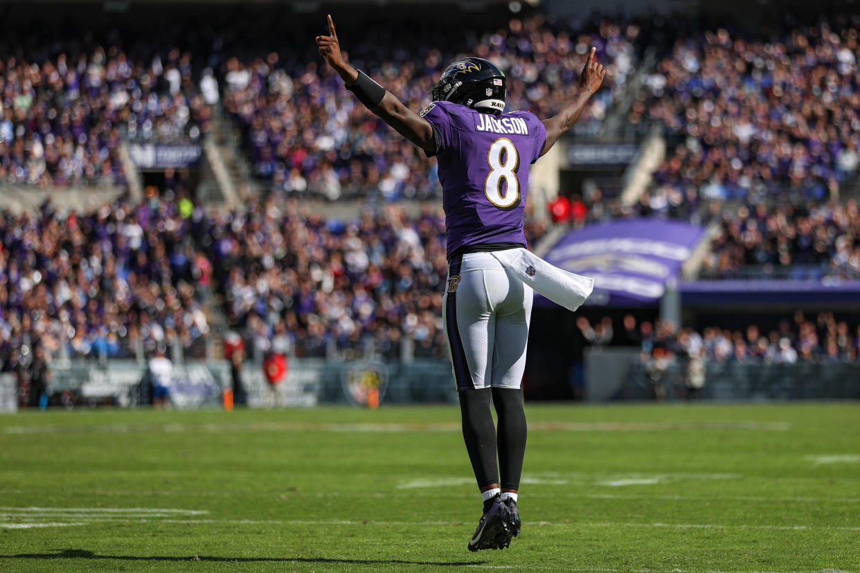 BALTIMORE, MARYLAND - OCTOBER 17: Quarterback Lamar Jackson #8 of the Baltimore Ravens celebrates a touchdown scored by Le'Veon Bell #17 during the second quarter against the Los Angeles Chargers at M&T Bank Stadium on October 17, 2021 in Baltimore, Maryland. (Photo by Patrick Smith/Getty Images)