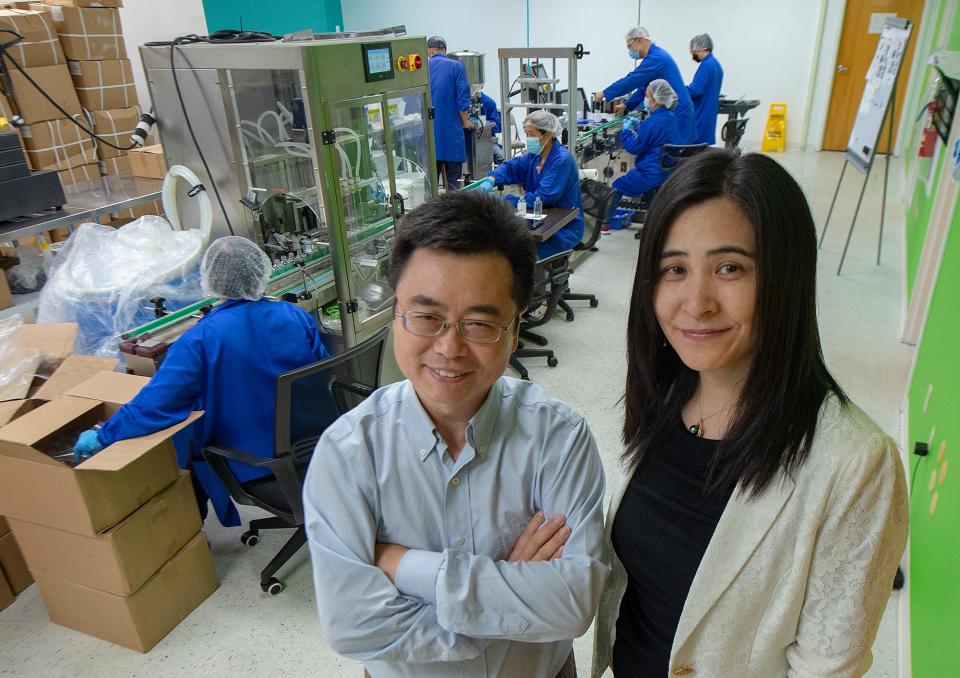 Fairy Gene co-owners Dr. Yong Liu, left, of Newtown, and Angie Li, of Newtown, with their employees filling and packaging cosmetics and skincare products, in Bristol, on Tuesday, Sept. 6, 2022.