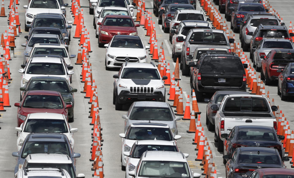 FILE - In this June 26, 2020, file photo lines of cars wait at a coronavirus testing site outside of Hard Rock Stadium in Miami Gardens, Fla. (AP Photo/Wilfredo Lee, File)