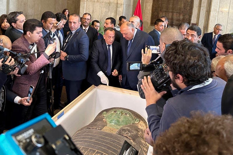 Egyptian officials with the repatriated sarcophagus.
