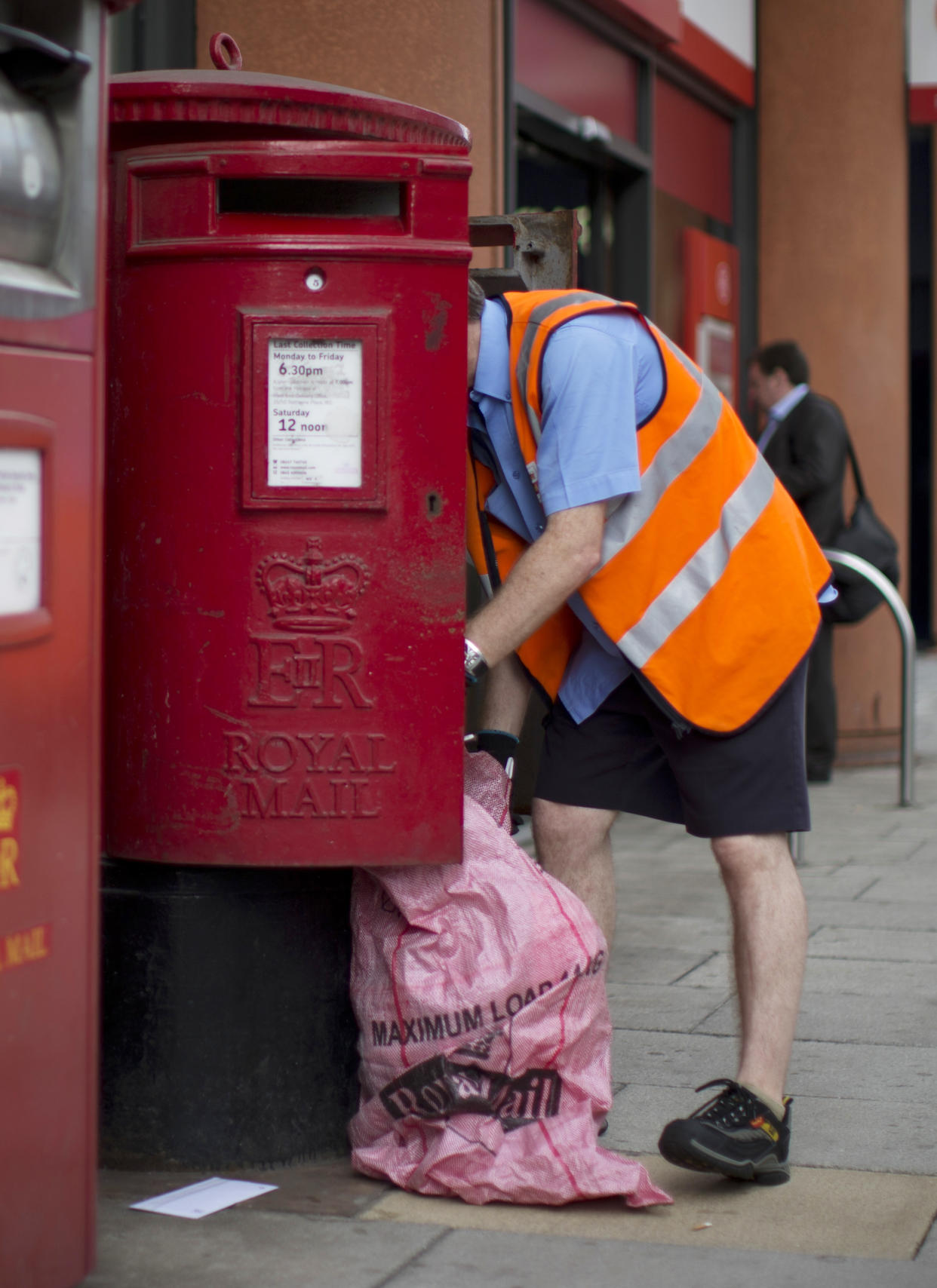 The Queen's official Elizabeth Regina II crest adorns British postboxes, among many other things.  (Matt Dunham / AP)