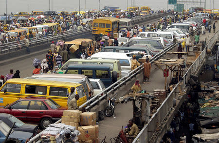 Commuters and traders park their vehicles on the Ido bridge in Lagos, Nigeria February 7, 2003. REUTERS/George Esiri/File Photo