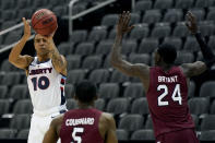 Liberty's Elijah Cuffee (10) shoots over South Carolina's Jermaine Couisnard (5) and Keyshawn Bryant (24) during the second half of an NCAA college basketball game Saturday, Nov. 28, 2020, at the T-Mobile Center in Kansas City, Mo. (AP Photo/Charlie Riedel)