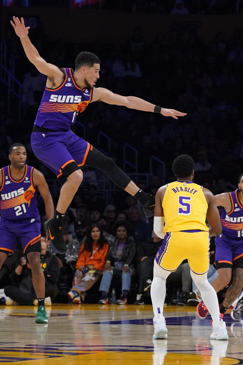 Los Angeles Lakers guard Malik Beasley, right, tries to shoot as Phoenix Suns guard Devin Booker defends during the first half of an NBA basketball game Wednesday, March 22, 2023, in Los Angeles. (AP Photo/Mark J. Terrill)