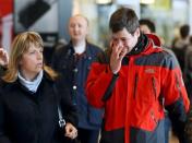 A family member of a passenger killed in Germanwings plane crash reacts as he arrives at Barcelona's El Prat airport March 24, 2015. REUTERS/Albert Gea