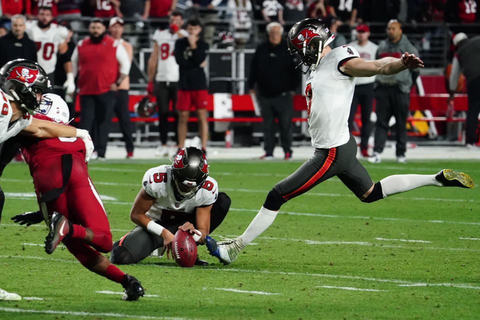 Tampa Bay Buccaneers place kicker Ryan Succop, right, kicks the game-winning field goal as Tampa Bay Buccaneers punter Jake Camarda (5) holds during the second half of an NFL football game against the Arizona Cardinals, Sunday, Dec. 25, 2022, in Glendale, Ariz. The Buccaneers defeated the Cardinals 19-16 in overtime. (AP Photo/Darryl Webb)