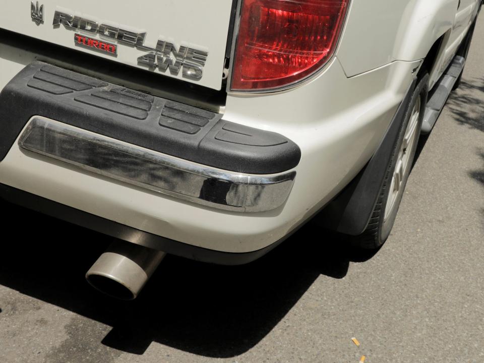 car tailpipe emits exhaust