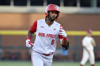 North Carolina State base runner Jose Torres (8) rounds the basses after hitting the go ahead home run against Arkansas in the ninth inning of an NCAA college baseball super regional game Sunday, June 13, 2021, in Fayetteville, Ark. (AP Photo/Michael Woods)