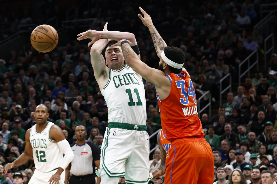 Oklahoma City Thunder's Kenrich Williams, right, knocks the ball away from Boston Celtics' Payton Pritchard during the first half of an NBA basketball game Wednesday, April 3, 2024, in Boston. (AP Photo/Winslow Townson)