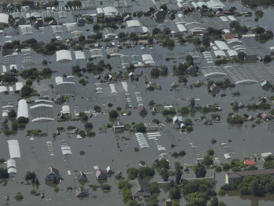 CAPTION CORRECTS LOCATION - Houses are seen underwater in the flooded village of Dnipryany, in Russian-occupied Ukraine, Wednesday, June 7, 2023, after the collapse of Kakhovka Dam. (AP Photo)