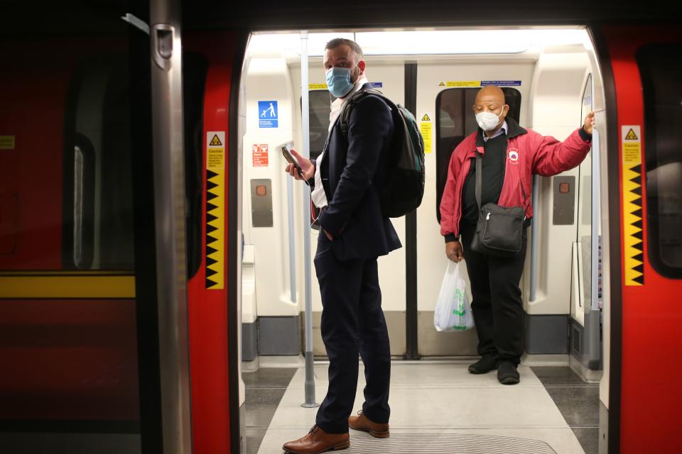 Passengers wearing PPE (personal protective equipment), including face masks as a precautionary measure against COVID-19, travel on a London Underground Tube train, in the evening rush hour at Waterloo station on May 11, 2020, as life in Britain continues during the nationwide lockdown due to the novel coronavirus pandemic. - The British government on Monday published what it said was a "cautious roadmap" to ease the seven-week coronavirus lockdown in England, notably recommending people wear facemasks in some public settings. But the devolved governments in Scotland and Wales have opted for a more cautious approach, keeping the strictest stay-at-home measures in place to contain the outbreak. (Photo by ISABEL INFANTES / AFP) (Photo by ISABEL INFANTES/AFP via Getty Images)