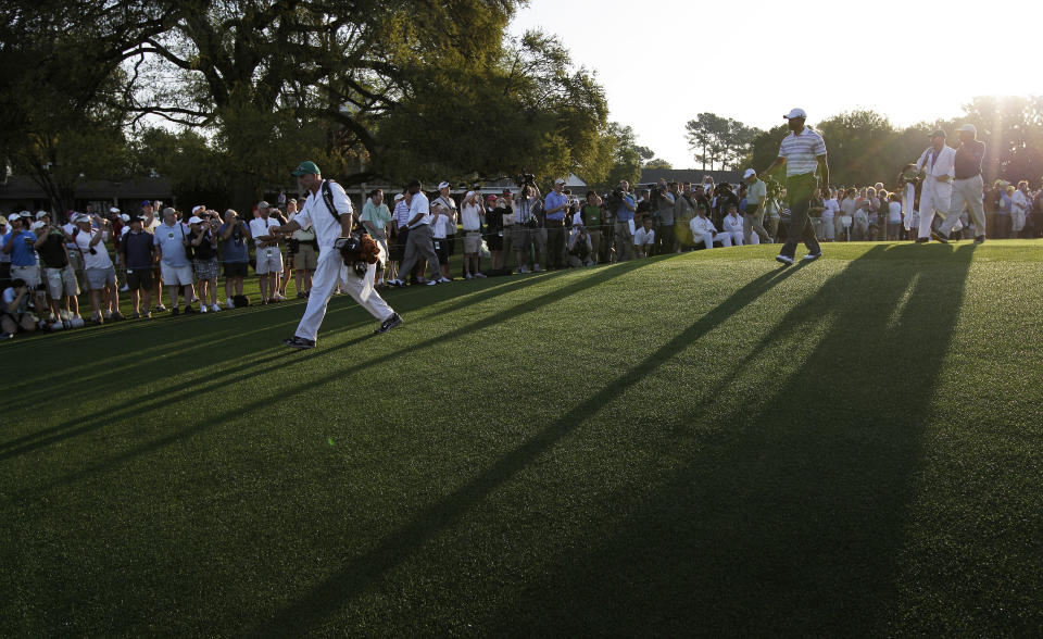 <p>Tiger Woods, third right, walks down the first fairway during a practice round for the Masters golf tournament in Augusta, Ga., Monday, April 5, 2010. The tournament begins Thursday, April, 8. (AP Photo/David J. Phillip) </p>