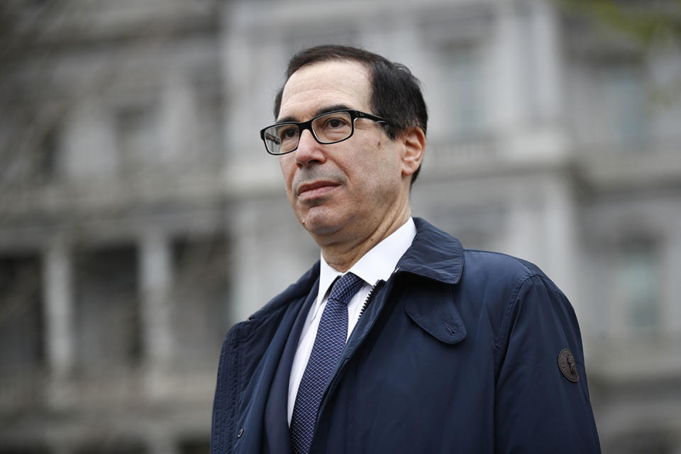 Treasury Secretary Steve Mnuchin speaks with reporters about economic impacts of the coronavirus outside the White House, Sunday, March 29, 2020, in Washington. (AP Photo/Patrick Semansky)