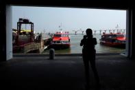 FILE PHOTO: Visitor from Hong Kong takes a photo of Turbojet ferries upon her arrival in Macau