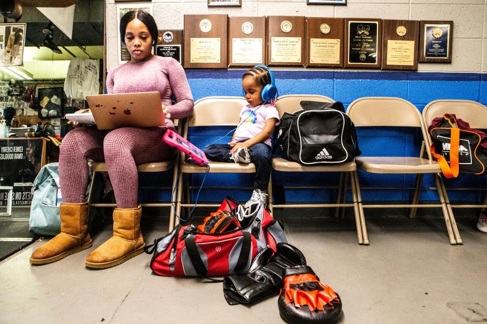 A mother and her daughter enjoy the sitting area of the boxing ring at the William "Hicks" Anderson Community Center in Wilmington, Wednesday, April 19, 2023. Hicks offers a variety of activities, including boxing, basketball, a gym, a game center, a computer room and a swimming pool for community members of all ages.