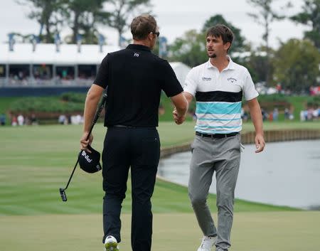 Mar 16, 2019; Ponte Vedra Beach, FL, USA; Ollie Schniederjans (right) and Seamus Power (left) shake hands on the 18th green after completing the third round of THE PLAYERS Championship golf tournament at TPC Sawgrass - Stadium Course. Mandatory Credit: Jasen Vinlove-USA TODAY Sports