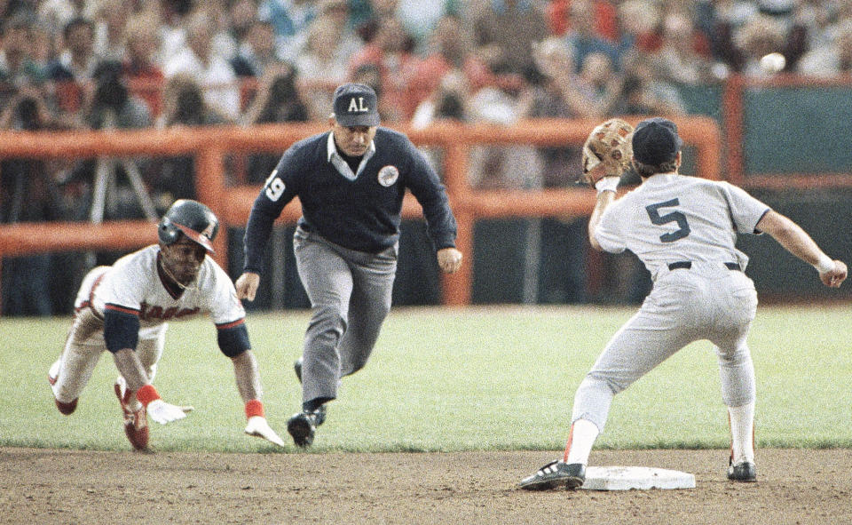 FILE - In this Oct. 11, 1986, file photo, California Angels' Gary Pettis, left, is caught stealing second base by Boston Red Sox shortstop Spike Owen (5) as umpire Richie Garcia, center, looks on during the third inning of a baseball game in Anaheim, Calif. Ten years after Garcia was fired by Major League Baseball, he wants to set the record straight: He did not get fired for trying to evaluate his son-in-law, then a minor league umpire. Garcia thinks baseball's top executives just wanted him out. (AP Photo/Jeff Robbins, File)