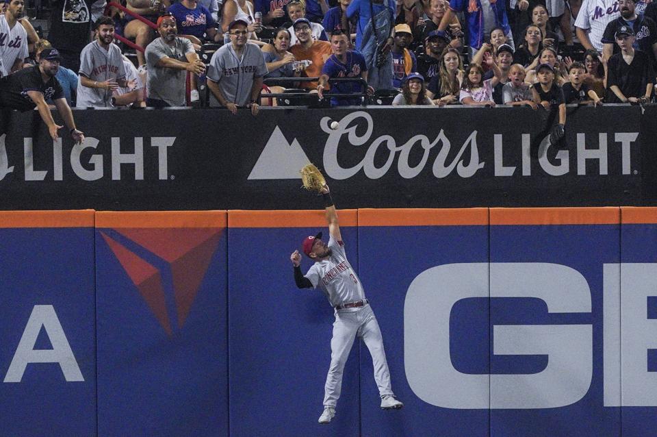 Cincinnati Reds right fielder Albert Almora Jr. leaps into the wall to catch out, during the fifth inning of a baseball game against New York Mets, Monday, Aug. 8, 2022, in New York. (AP Photo/Bebeto Matthews)