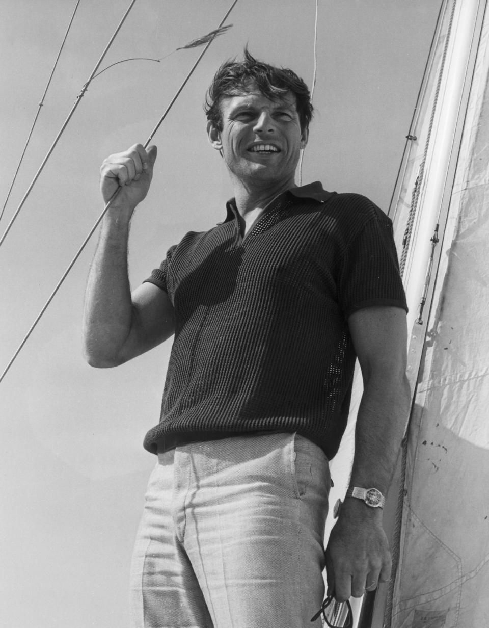 Adam West stands on a sailboat, circa 1965