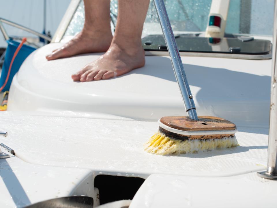 A man is washing a boat.