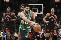 Toronto Raptors guard Gary Trent Jr. tries to take the ball from Boston Celtics forward Jayson Tatum during the second half of an NBA basketball game in Toronto, Monday, Dec. 5, 2022. (Chris Young/The Canadian Press via AP)