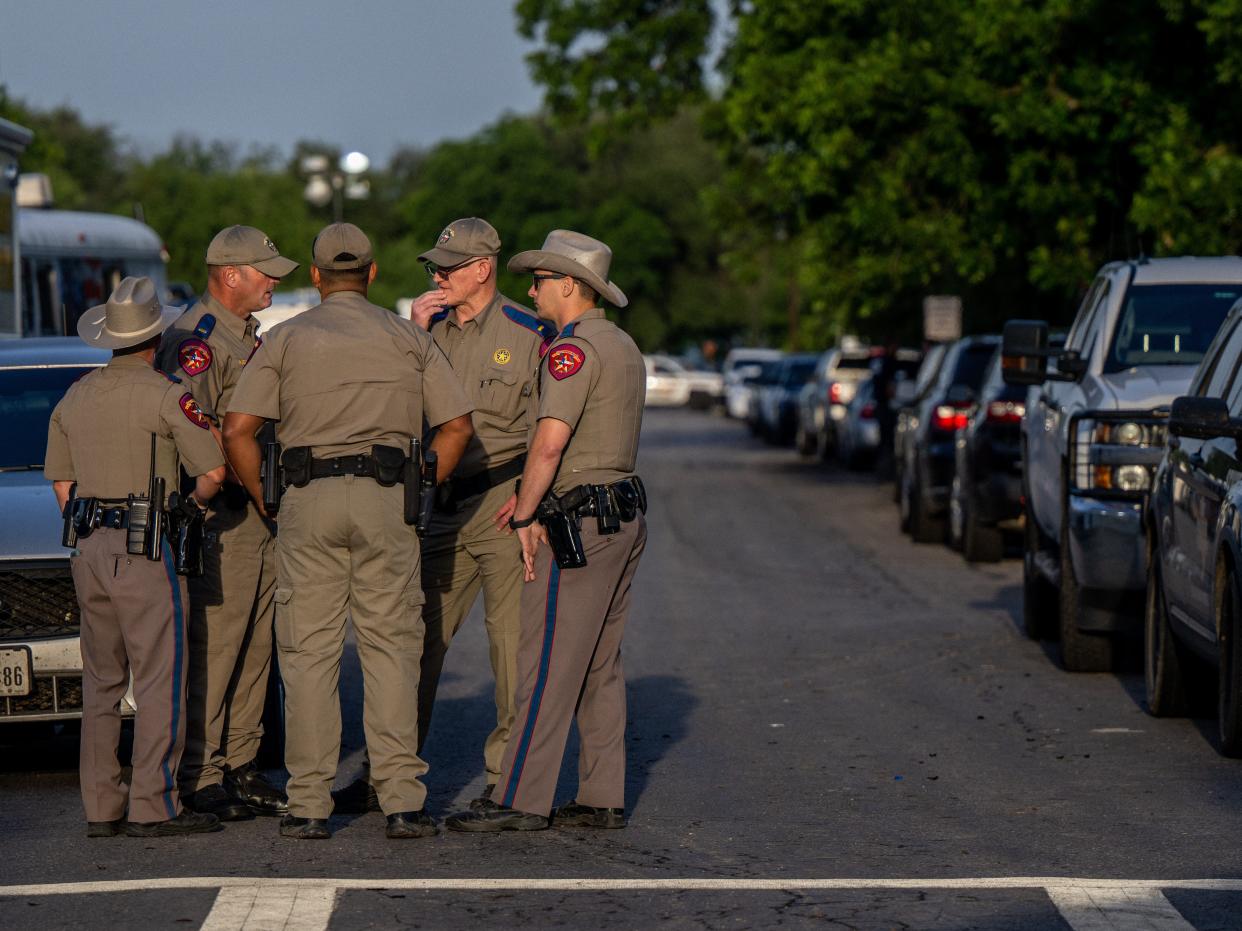 Law enforcement officers gather outside of Robb Elementary School following the mass shooting there on May 25, 2022 in Uvalde, Texas.