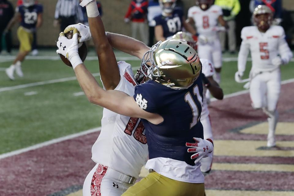 Notre Dame wide receiver Ben Skowronek (11) makes a touchdown reception against Boston College defensive back Brandon Sebastian (10) during the first half of an NCAA college football game, Saturday, Nov. 14, 2020, in Boston. (AP Photo/Michael Dwyer)