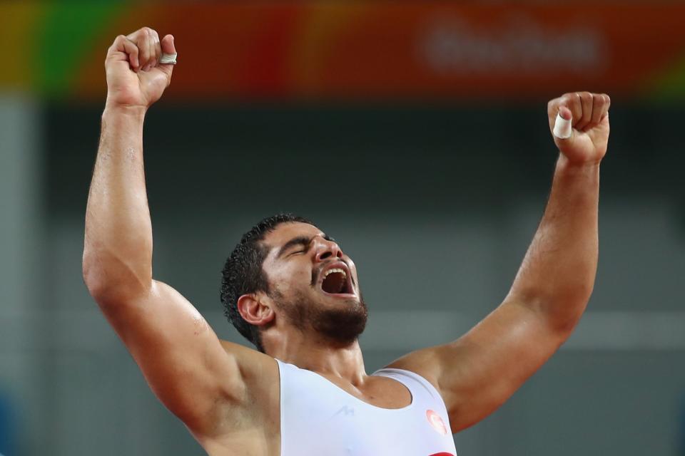 <p>Taha Akgul of Turkey celebrates victory against Komeil Nemat Ghasemi of the Islamic Republic of Iran in the Men’s Freestyle 125kg Gold Medal bout on Day 15 of the Rio 2016 Olympic Games at Carioca Arena 2 on August 20, 2016 in Rio de Janeiro, Brazil. (Photo by Clive Brunskill/Getty Images </p>