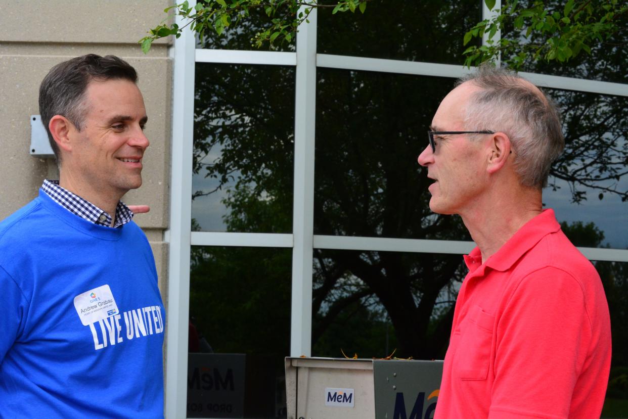 Heart of Missouri United Way President and CEO Andrew Grabau chats Friday with Jim Lisenbardt, who has signed up with the United Way's Give 5 Program. A series of classes introduces and connects retirees to volunteer programs and opportunities in Columbia.