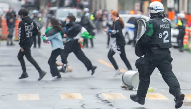 Pro-Palestinian protesters run from police following a demonstration in Montreal on Sunday.