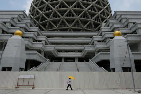 A woman walks inside Dhammakaya temple in Pathum Thani province, Thailand, March 9, 2017. REUTERS/Athit Perawongmetha