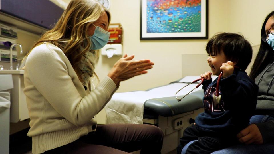 A staff member works with a child at the Holland Community Health Center.