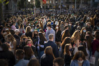 FILE - In this file photo dated Friday, April 23, 2021, people wearing face masks crowd along a street of Barcelona to buy books and roses at makeshift stands as Catalans celebrate the day of their patron saint, Sant Jordi, or Saint George in English, an important holiday in Catalan culture. The 27-nation European Union has recommended that restrictions be lifted for American tourists, with travellers and the businesses that rely on them being eager for things to return to something resembling normal. (AP Photo/Emilio Morenatti, FILE)