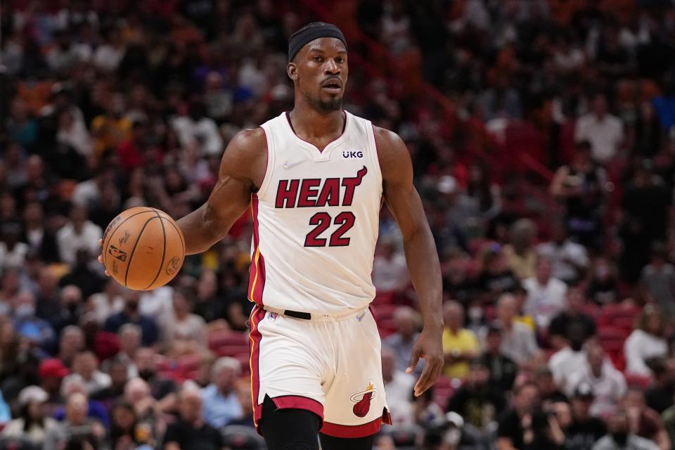 Miami Heat forward Jimmy Butler dribbles the ball up the court during the game against the Golden State Warriors.
